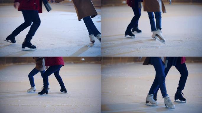 浪漫的冬天下雪的夜晚: 滑冰夫妇在溜冰场上玩得开心。户外双人滑冰。男女朋友培训。中等关注腿部和冰鞋