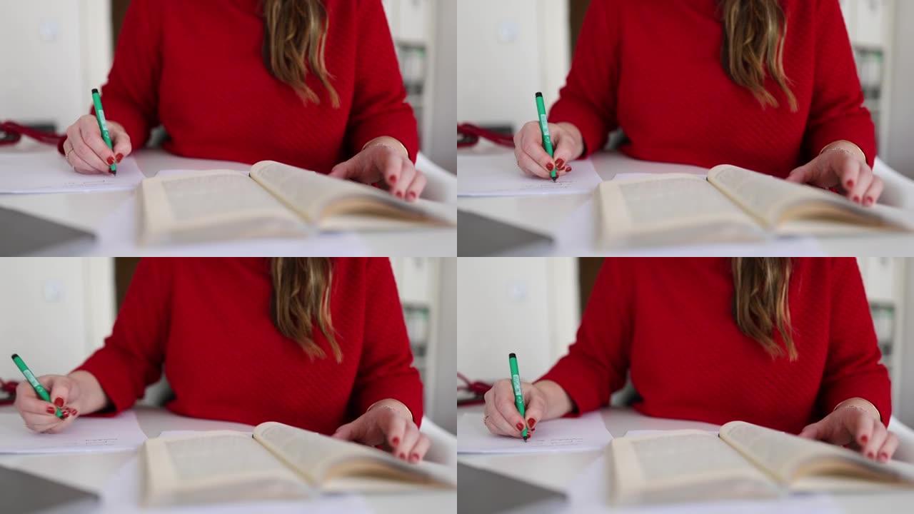 一个女人读一本书和做笔记的特写