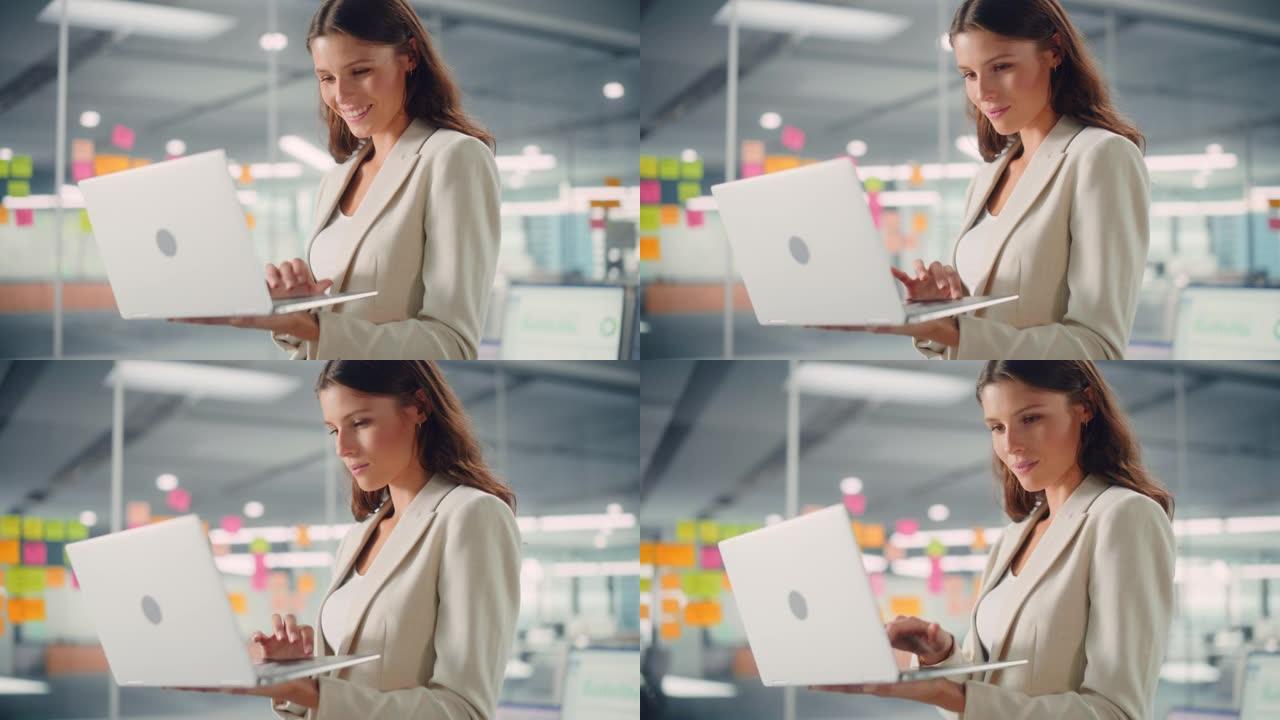 年轻自信的女商人在现代办公室与同事一起使用笔记本电脑。时尚漂亮的经理，从事商业、金融和营销项目。多元