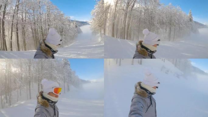 自拍照: 年轻女子在有雾的滑雪胜地小径上活跃度假滑雪板。