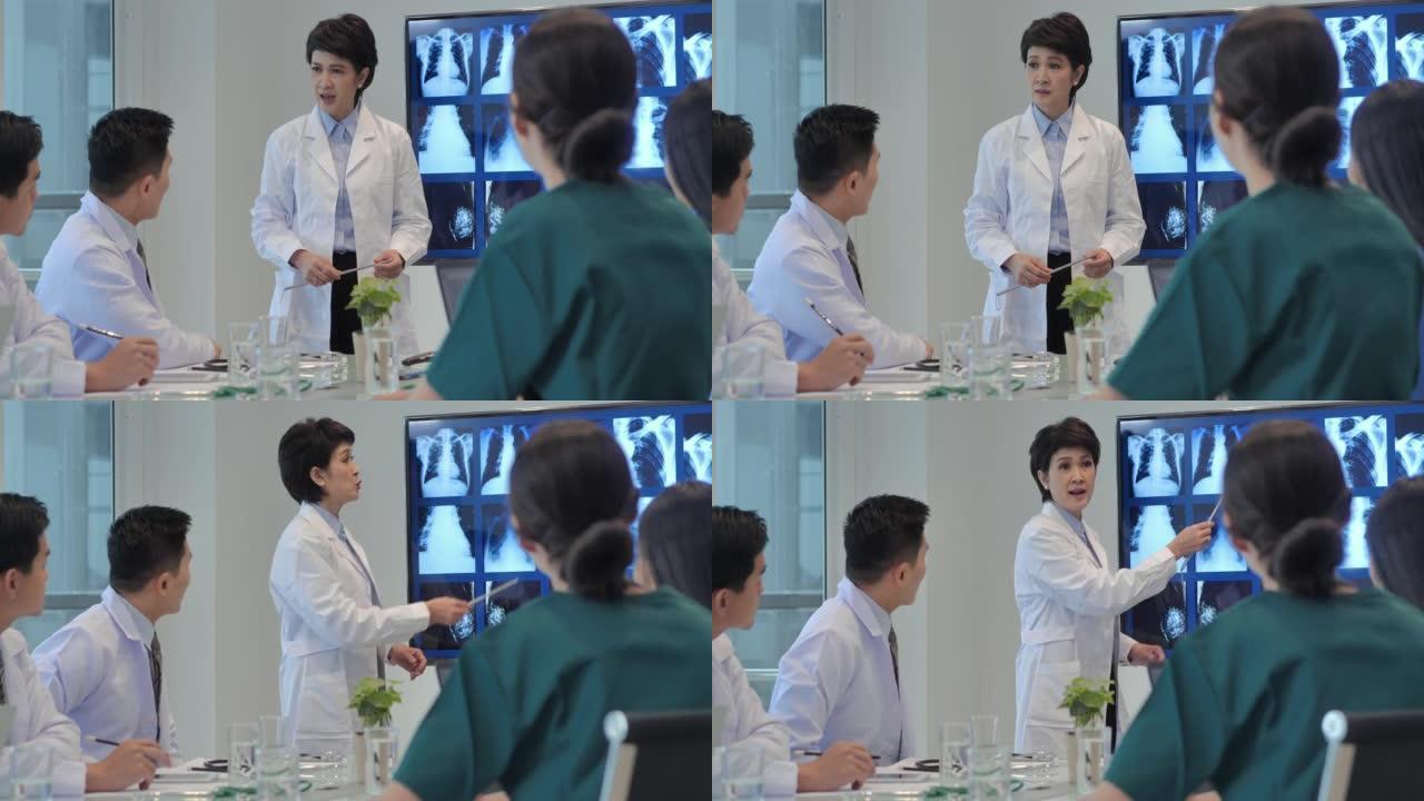 自信的亚洲医生女性在医院会议室向医务人员做演讲。