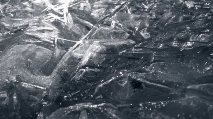 冰面。背光源结冰的河面。冰颗粒-冷冻水宏观射击。高质量，UHD