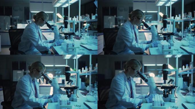 医学研究科学家在应用科学实验室的数字显微镜下观察生物样品。穿着白大褂的美丽高加索实验室工程师，从事疫