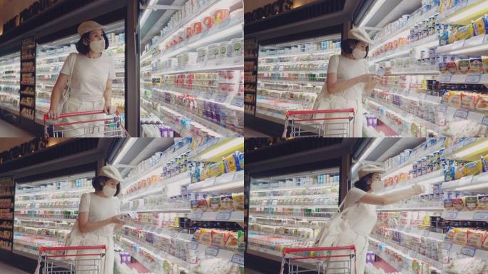 戴着防护口罩在超市购物的年轻女孩。