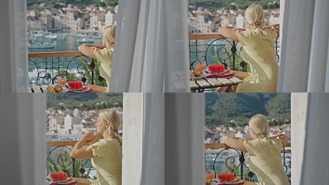 SLO MO女人在海景阳台上吃早餐