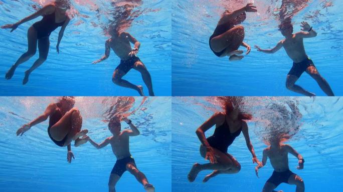 亚洲华裔女游泳运动员与游泳教练在游泳池练习翻筋斗