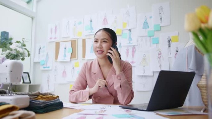 时装设计师学院大学生在服装工作室工作。