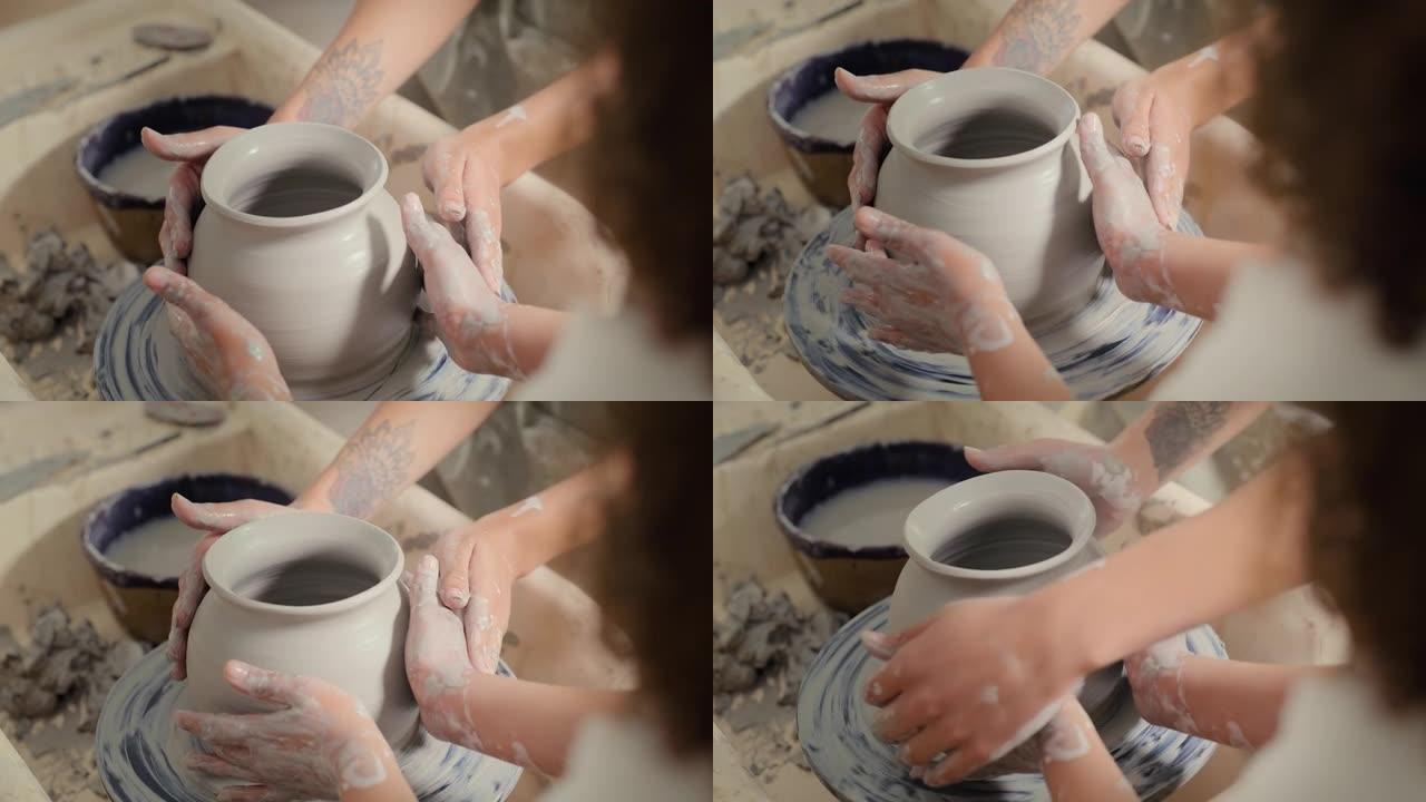 陶器，碗的设计以及儿童学生和老师的手一起用粘土支撑花瓶。创意工作坊，艺术学习和创意设计师班，一个孩子
