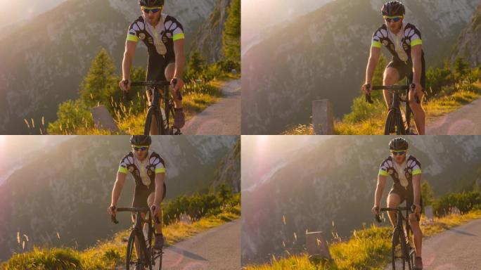 坚定的运动员路骑自行车上山风景秀丽的山路，被阳光照亮