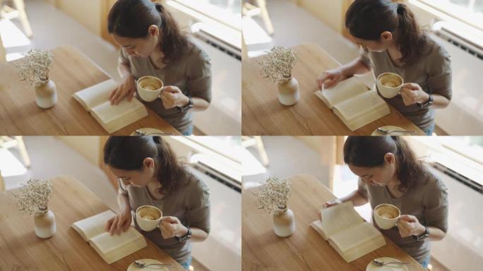亚洲女人用咖啡杯看书，在日常生活活动中放松