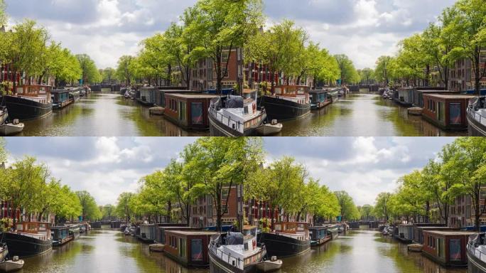 在一个美丽的晴天，用船和船屋俯瞰阿姆斯特丹河运河