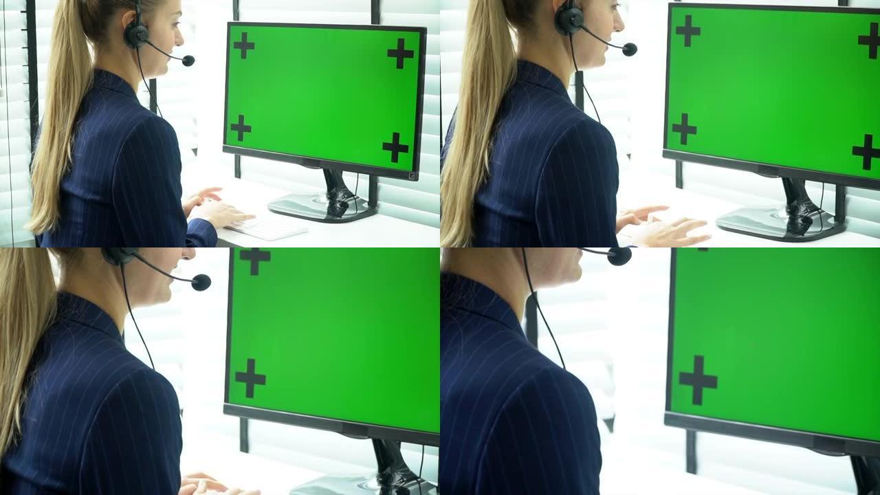 使用绿屏计算机将相机放大到屏幕上的女商人