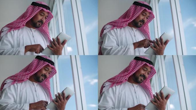 使用数字平板电脑的阿拉伯商人