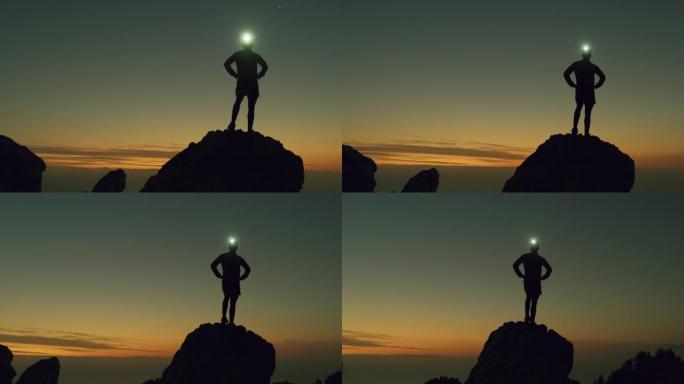 4k视频片段，一名男子在登山时戴着头灯