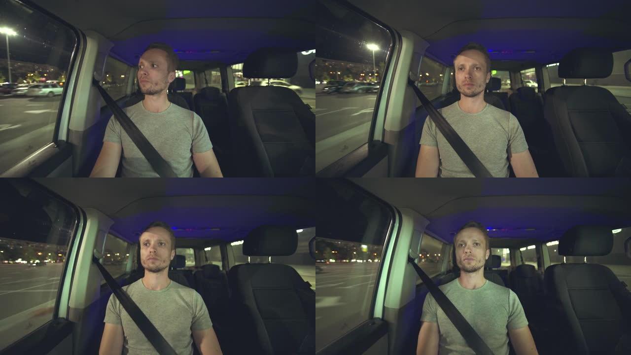 男人晚上开车。车辆内部视图