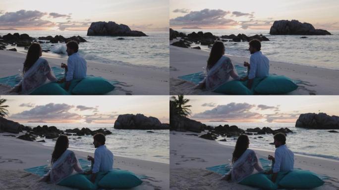日落时分，浪漫的情侣在美丽的热带岛屿上享受日落