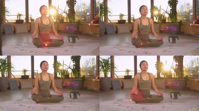 慢动作: 亚洲女性在莲花姿势冥想练习呼吸技术