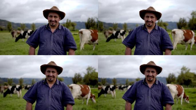 拉丁美洲的男性农民在奶牛场面对镜头愉快地微笑