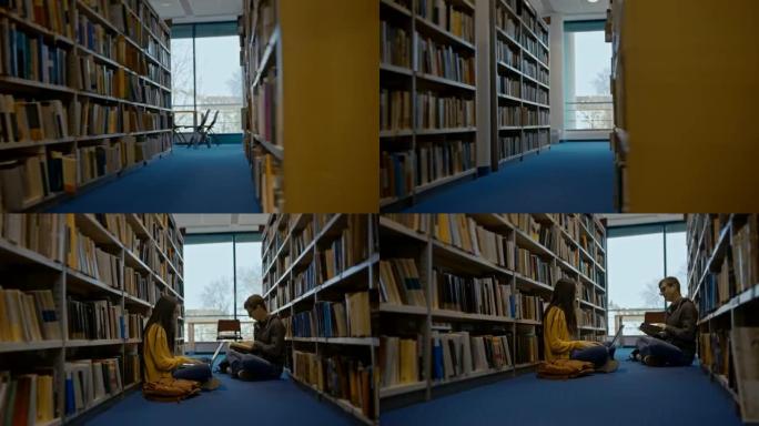 SLO MO两个学生在图书馆书架之间的地板上学习