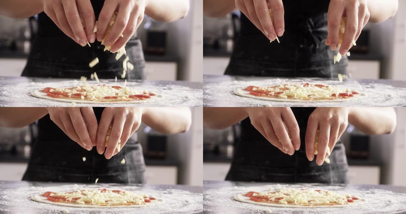 4k视频片段，一个无法识别的女人在将奶酪放入烤箱之前将奶酪撒在比萨饼上