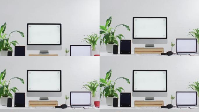 笔记本电脑、智能手机、平板电脑和电脑在木桌上的视频，办公室有复印空间