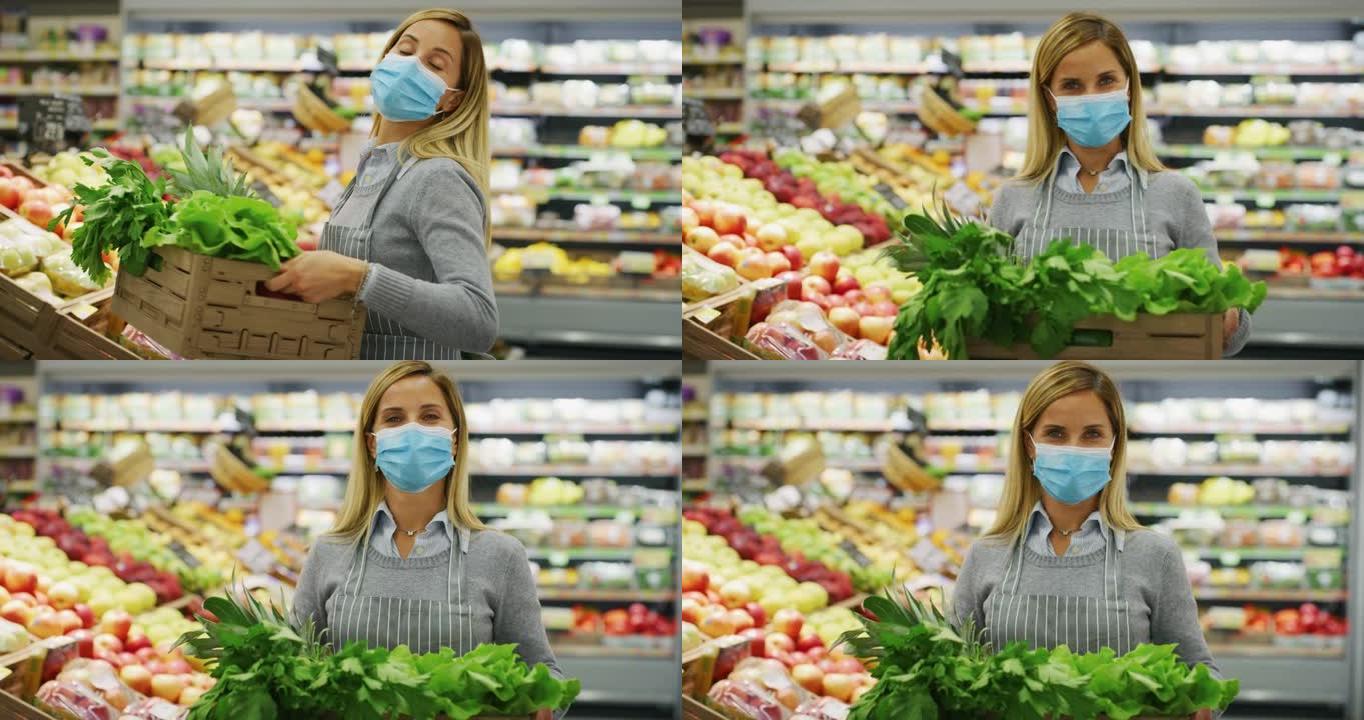 图为，在超市有机食品部工作的女职员戴着医用口罩，背着装着新鲜蔬菜的木箱，对着镜头满意地看着自己的工作