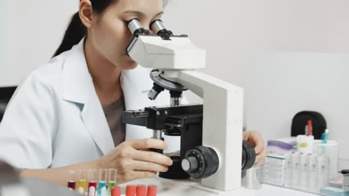 科学家在光学显微镜上进行研究