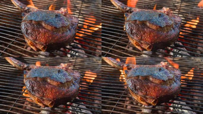 木火烤架上带有完美烧烤痕迹的多汁战斧牛排的特写镜头