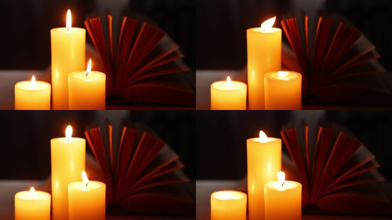 蜡烛照着桌子上的一本打开的书