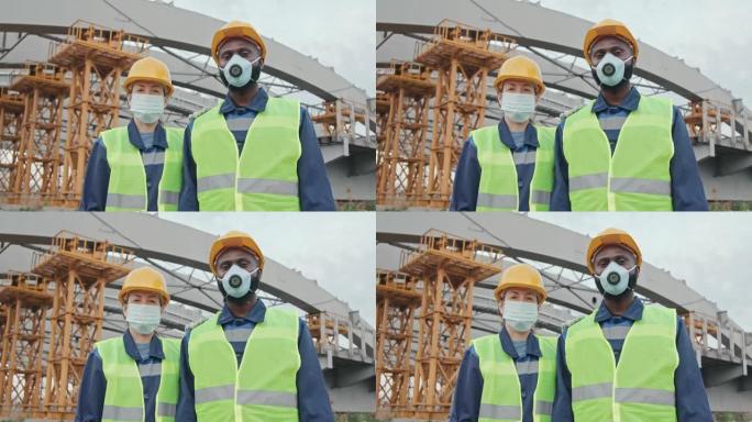 戴口罩的多民族建筑工人摆姿势