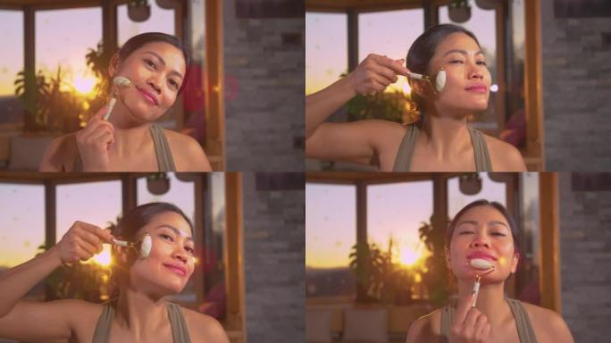 肖像: 享受刮痧玉辊面部按摩的亚洲美女