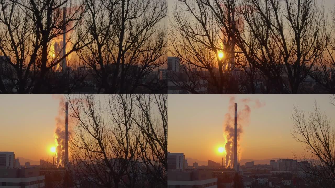 空中: 高大的供暖厂烟囱耸入燃烧的橙色夜空。
