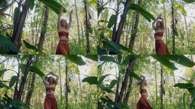 快乐的女人在森林里跳舞在郁郁葱葱的热带丛林4k享受自然舞蹈