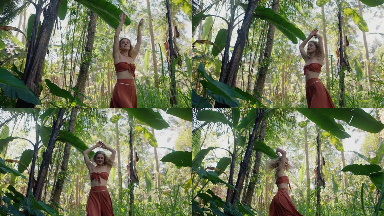 快乐的女人在森林里跳舞在郁郁葱葱的热带丛林4k享受自然舞蹈