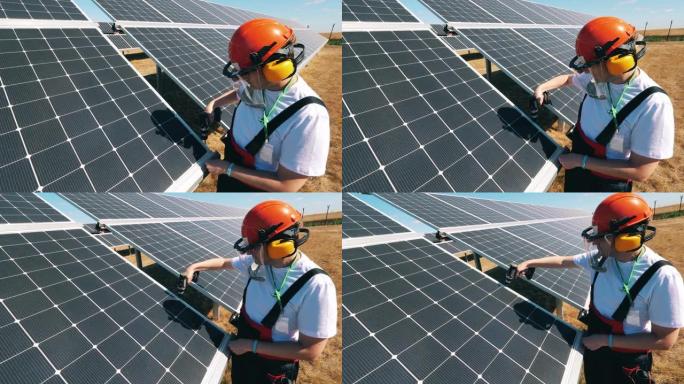 一名男性专家正在修理太阳能电池板。能源效率，节能理念。