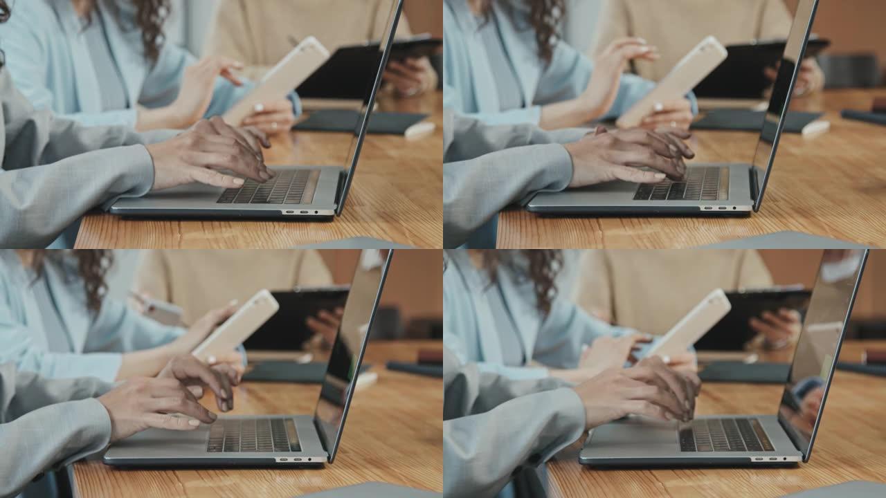 在笔记本电脑上工作的无法识别的女商人的Slowmo