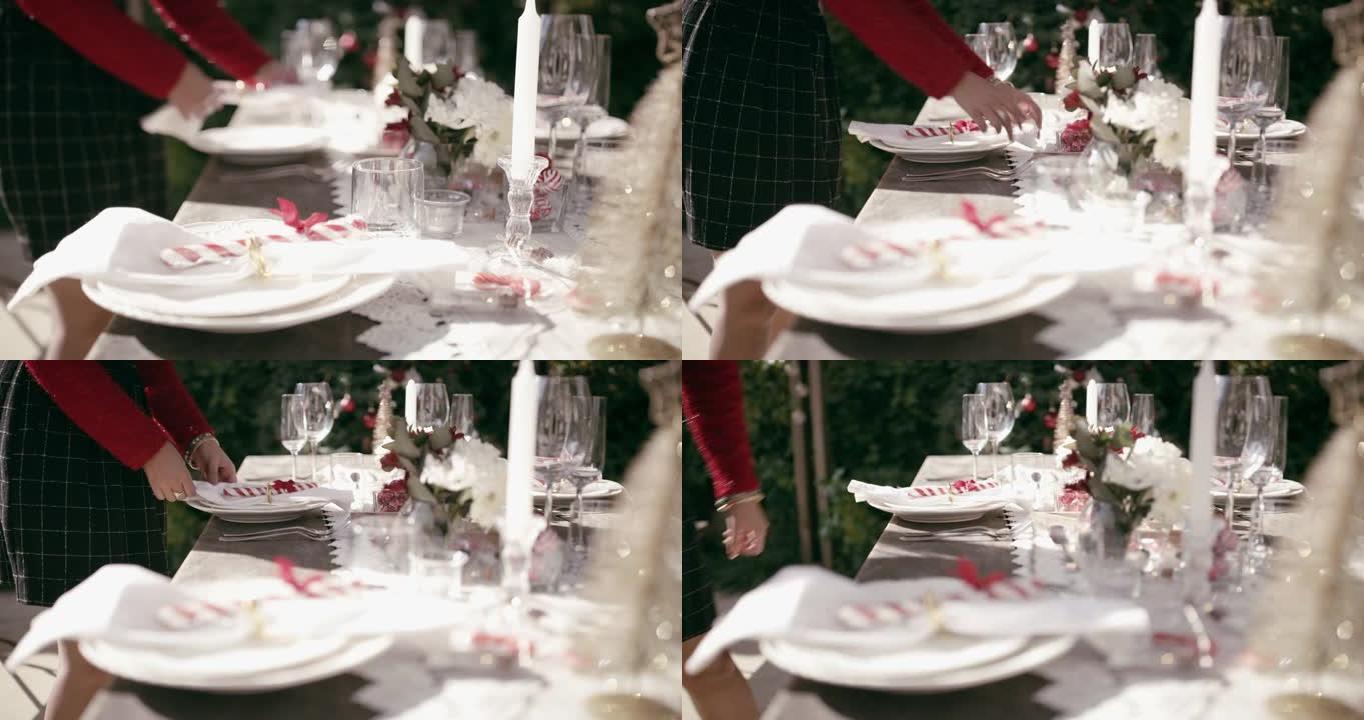 4k视频片段，一名面目全非的女人在家里摆桌子，为圣诞节聚会做准备