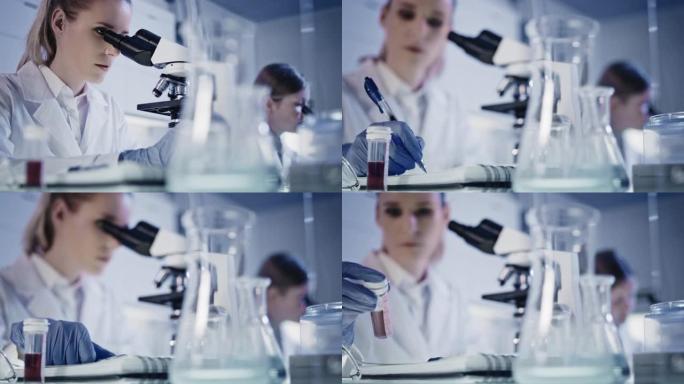 处理实验室样本。使用显微镜的女人。浏览玻璃器皿