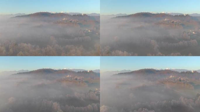 空中: 飞越雾谷，朝山上的一个小村庄飞去。