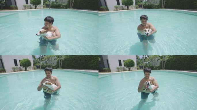 亚洲男子在游泳池里抱着和抚摸他的快乐狗