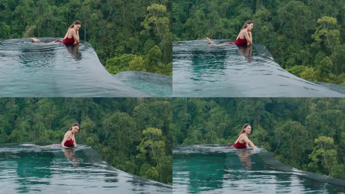 旅行女子穿着比基尼在游泳池放松，在豪华酒店水疗中心享受度假生活方式，可以看到热带丛林4k