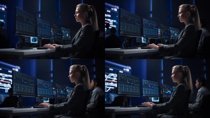 自信的女性数据科学家在大型基础设施控制室的个人计算机上工作。股市女性专家使用计算机显示图表，图表，信