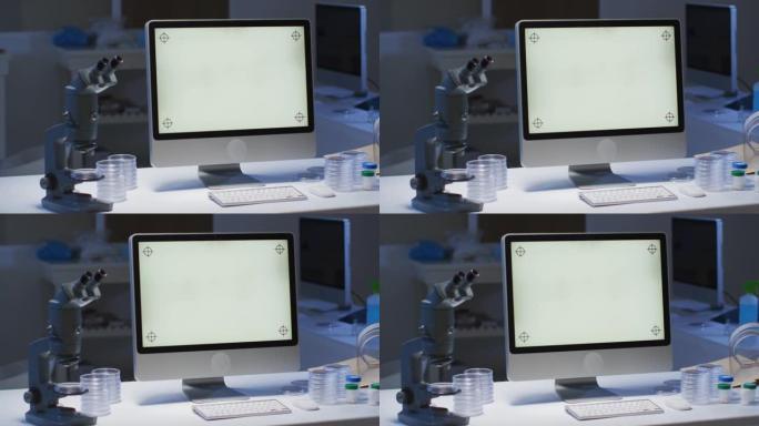 在空实验室的工作站上带有照明屏幕的台式计算机