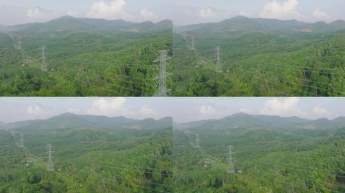 电塔的鸟瞰图，森林中的山上的电力线。经典的能源概念。