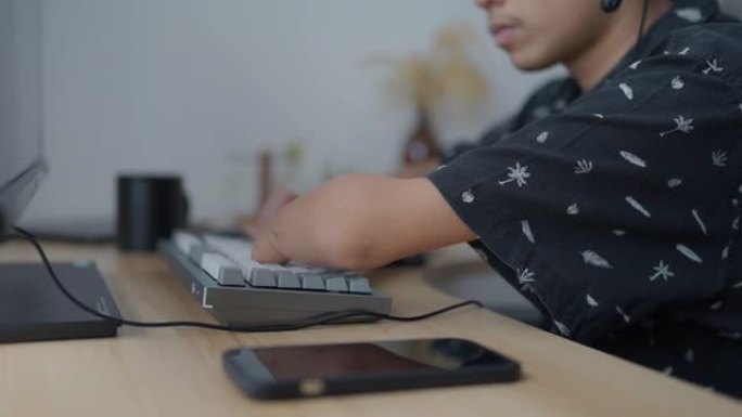 家庭办公室里残疾男子使用电脑。