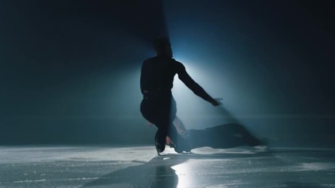 一对年轻的花样滑冰运动员的电影镜头正在比赛开始前在溜冰场上进行双人滑冰编舞。完美、精确、自由、激情的