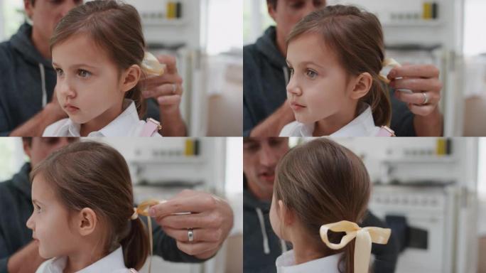 父亲让女儿为上学做好准备爸爸帮助小女孩在头发上鞠躬亲吻她的再见4k