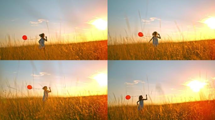 超级SLO MO女孩在日落时在草地上奔跑时拿着一个红色气球