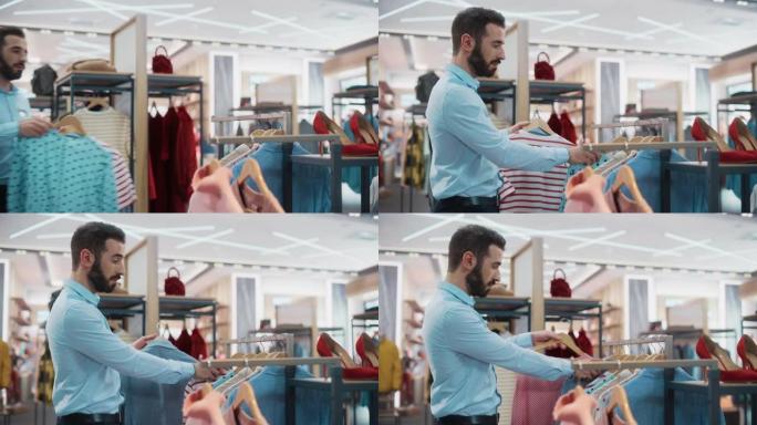 帅气男服装店助理在时尚商场工作。专业商店销售零售助理将具有可持续休闲设计的新彩色系列悬挂在展示架上。