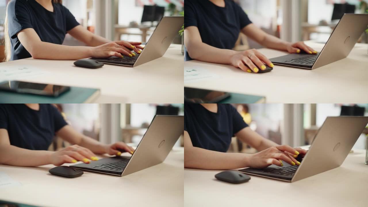 在晴天，穿着黑色便装的女员工在办公室的笔记本电脑上工作。用醒目的黄色指甲油在计算机上键入文本，编写电